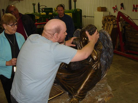 Tony touching angel statue