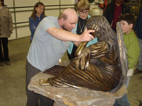 Tony touching angel statue