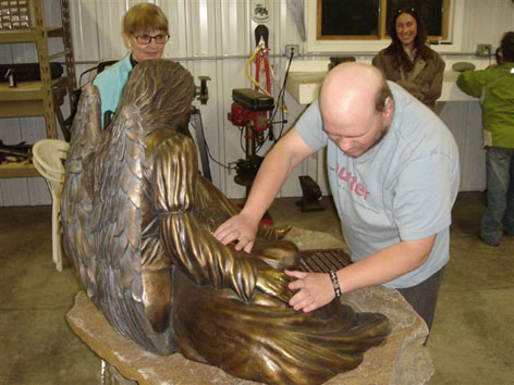 Tony touching angel statue