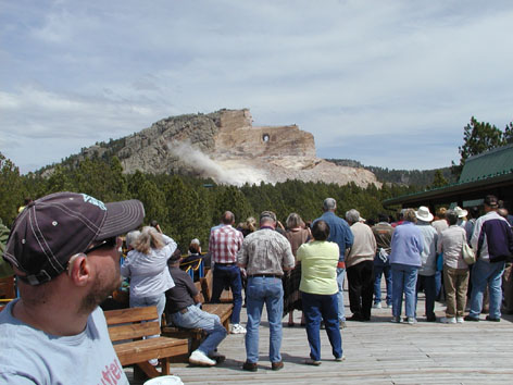 People watching dust from an explosion on the mountain. Tony in the foreground.