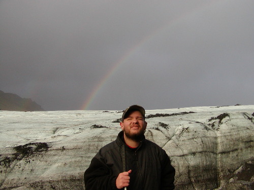 Tony at Myrdalsjokull glacier with rainbow in the background