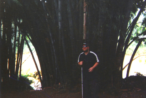 Tony stood by a large bamboo tree, Peradeniya Botanical Gardens, Kandy