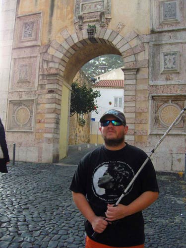 Tony in front of an archway leading into the castle